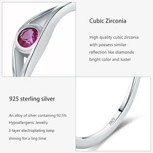 Silver ring with a pink gemstone and text about cubic zirconia and 925 sterling silver.