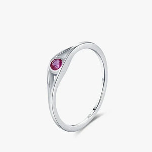 Silver ring with a pink gemstone on a white background