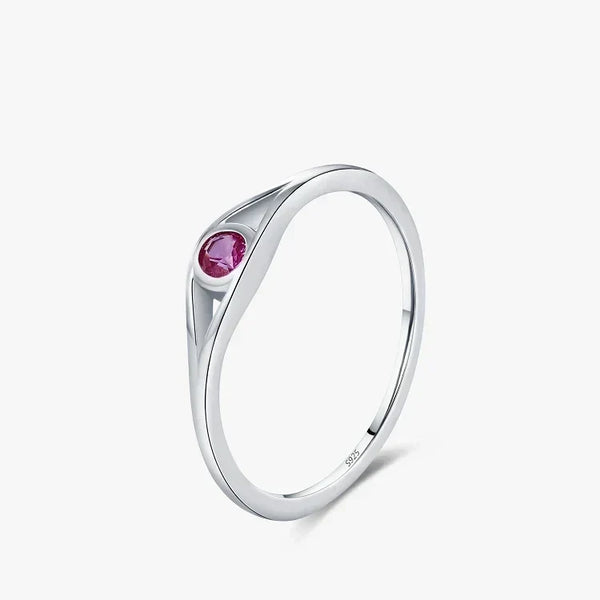 Silver ring with a pink gemstone on a white background