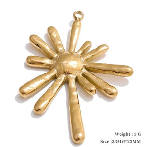 Gold sun-shaped pendant on a white background
