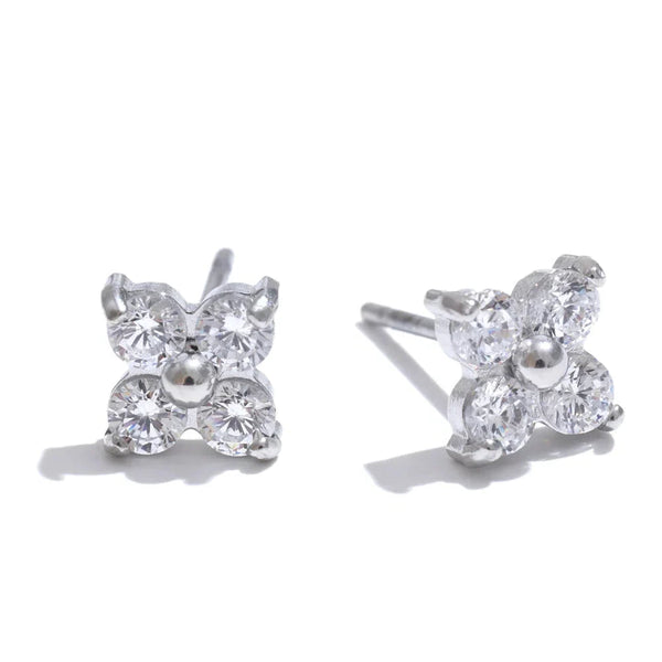 Butterfly-shaped silver earrings with clear gemstones on a white background