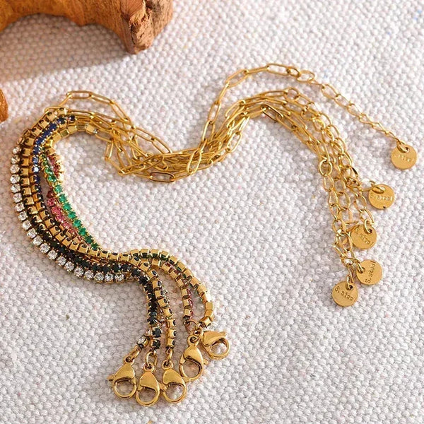 Gold-plated adjustable bracelets with sparkling colored crystals on textured fabric