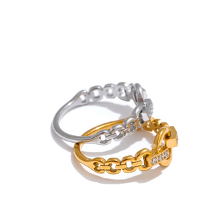 Two rings, one silver and one gold, on a white background