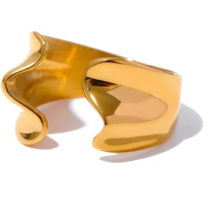 Gold cuff bracelet on a white background