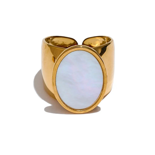 Gold ring with a light blue stone on a white background