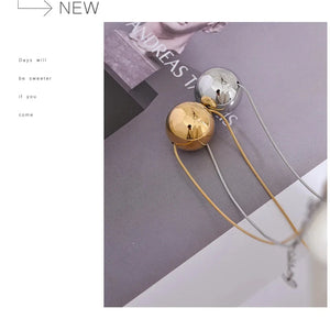 Gold and silver earrings on a gray surface with text overlay