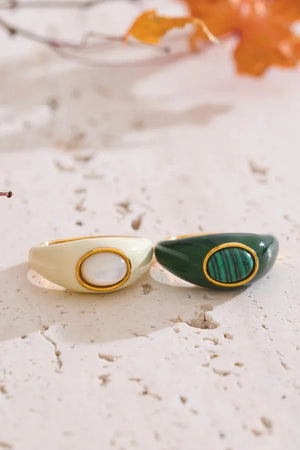 Two decorative items with green and gold accents on a textured surface.