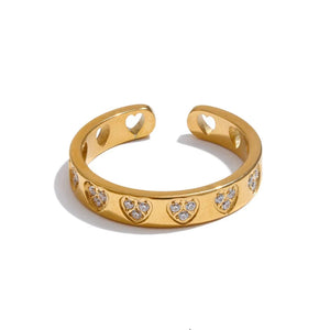 Gold ring with heart designs and 'ya pur' branding on a white background