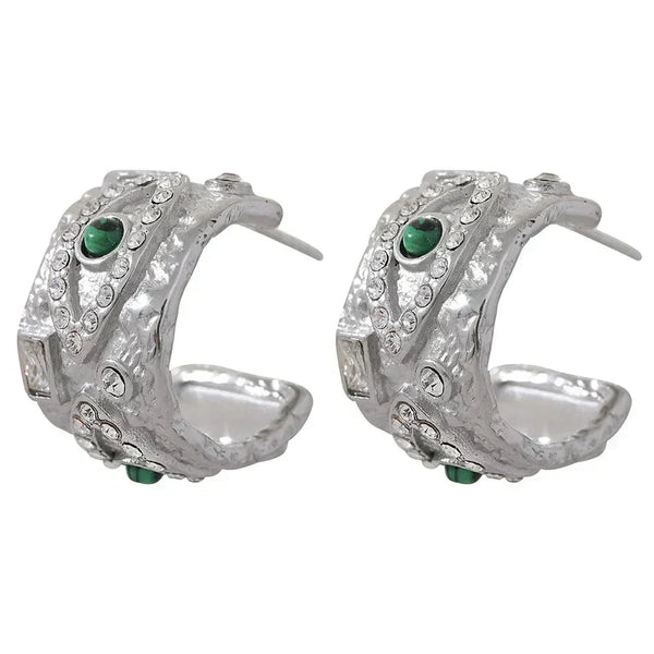 Pair of silver hoop earrings with green gemstones on a white background