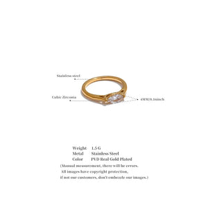 Gold ring with cubic zirconia stone on a white background