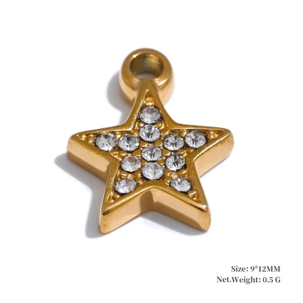 Gold star-shaped pendant with embedded crystals on a white background