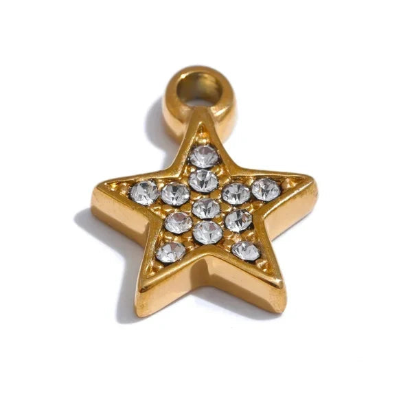 Gold star-shaped pendant with embedded crystals on a white background