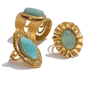 Gold rings with turquoise stones on a white background.