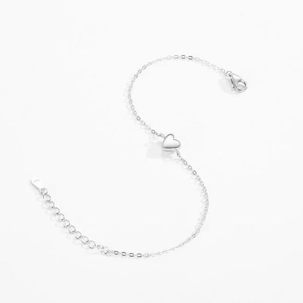 Silver Mia Heart Bracelet - TM & CO. JEWELS with a heart-shaped charm on a white background