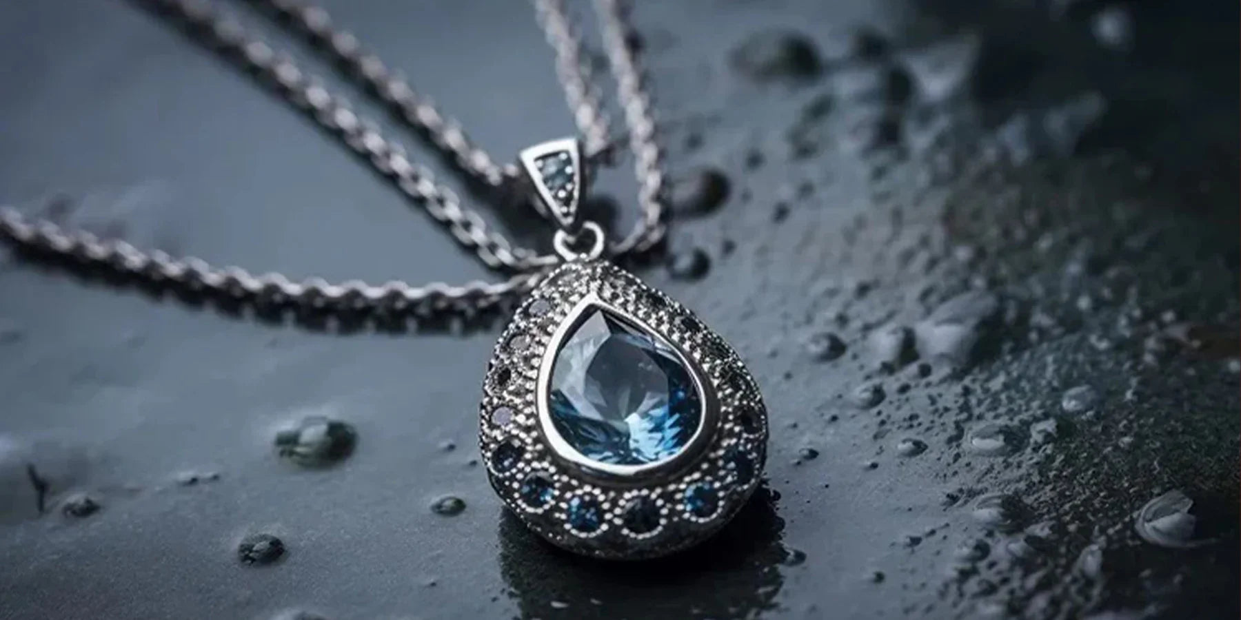 Handcrafted sterling silver teardrop necklace featuring a brilliant blue gemstone, styled for elegant gifting.