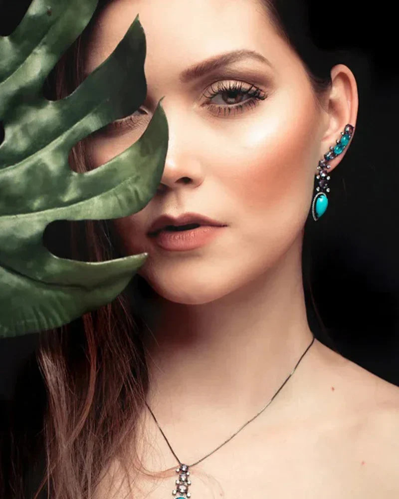 Detailed close-up of vibrant teal gemstone earrings and luxury handcrafted jewelry for the Colorful Expression collection.