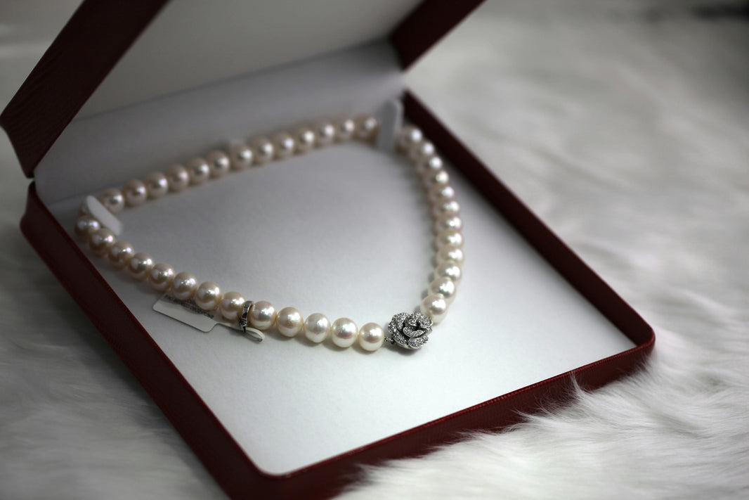 Pearl necklace in a jewelry box on a soft surface