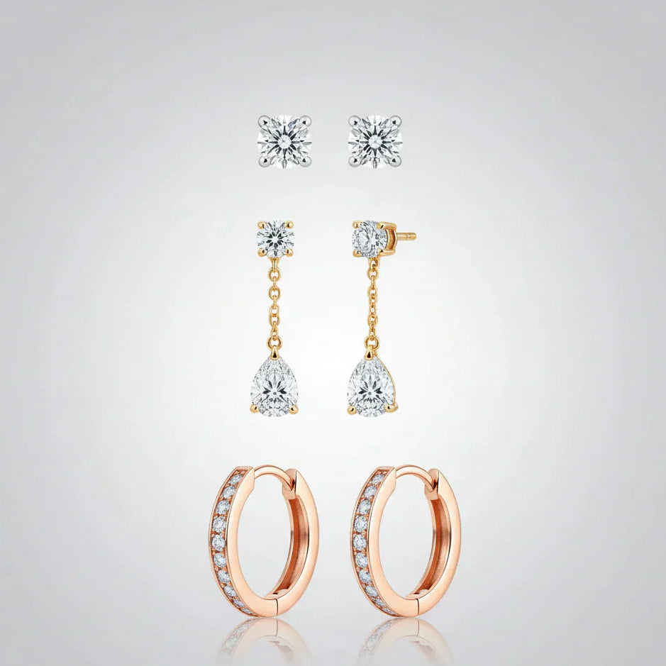 A curated trio of earrings from the TM & Co. Jewels collection, featuring classic studs, drop designs, and hoop earrings in a quality-crafted finish.
