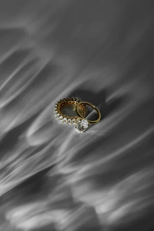 A quality-crafted, timeless gold and diamond ring stack from the TM & Co. Jewels collection, captured in an artistic light.